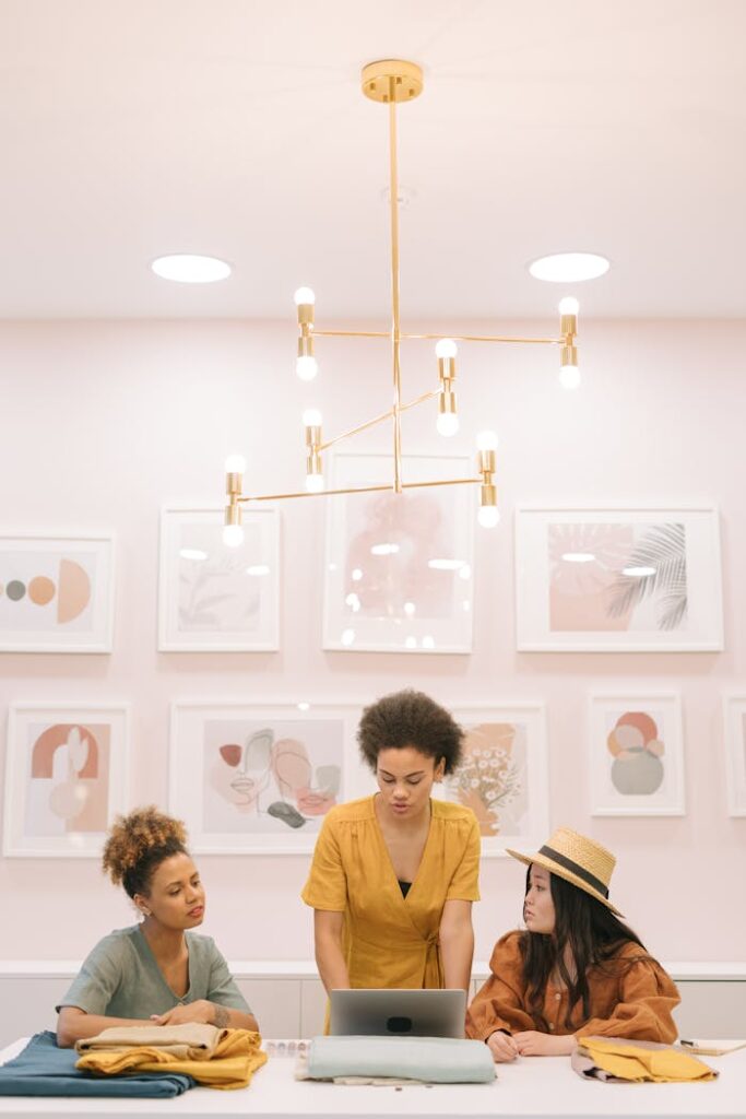 pexels photo 8483659 Diverse team of three women collaborating in a stylish design studio setting.